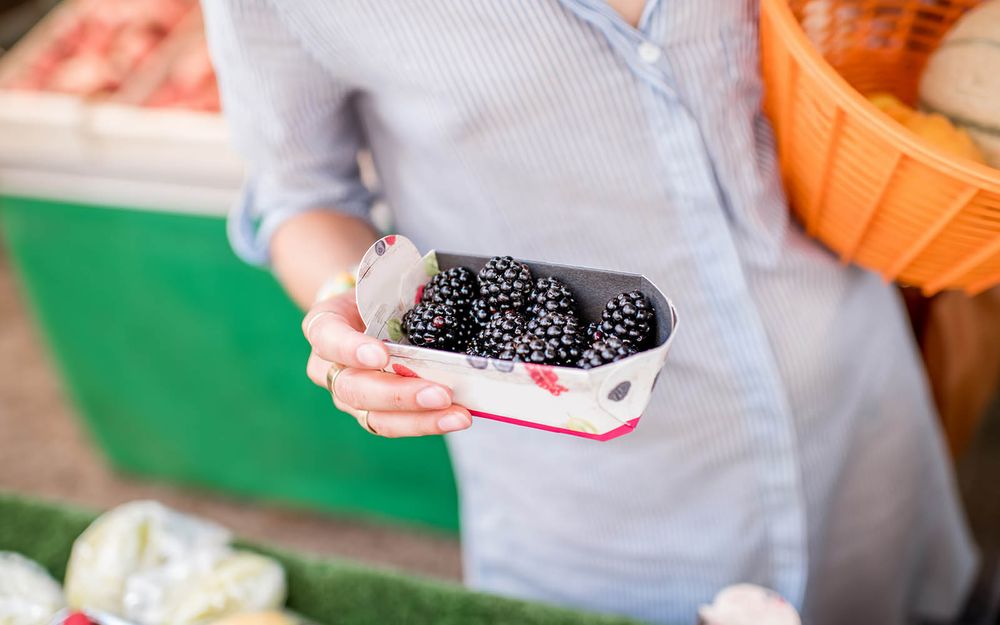 Idiot holding pint of blackberries at the store.