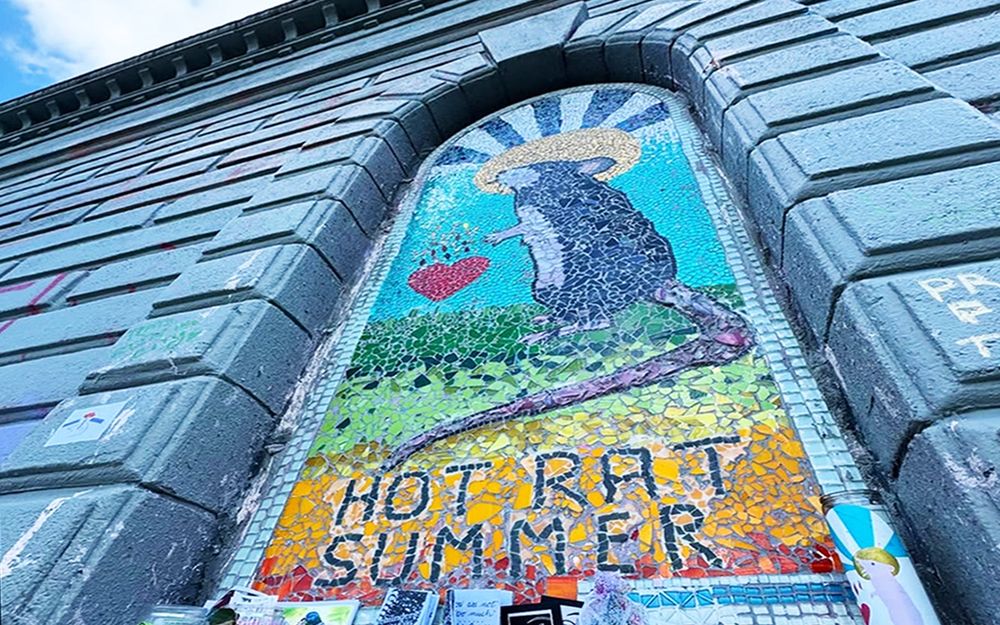 Colorful St. Rat mosaic in Seattle's Capitol Hill featuring a rat with St. Elmo's fire behind head and wording at the bottom reading "Hot Rat Summer." 
