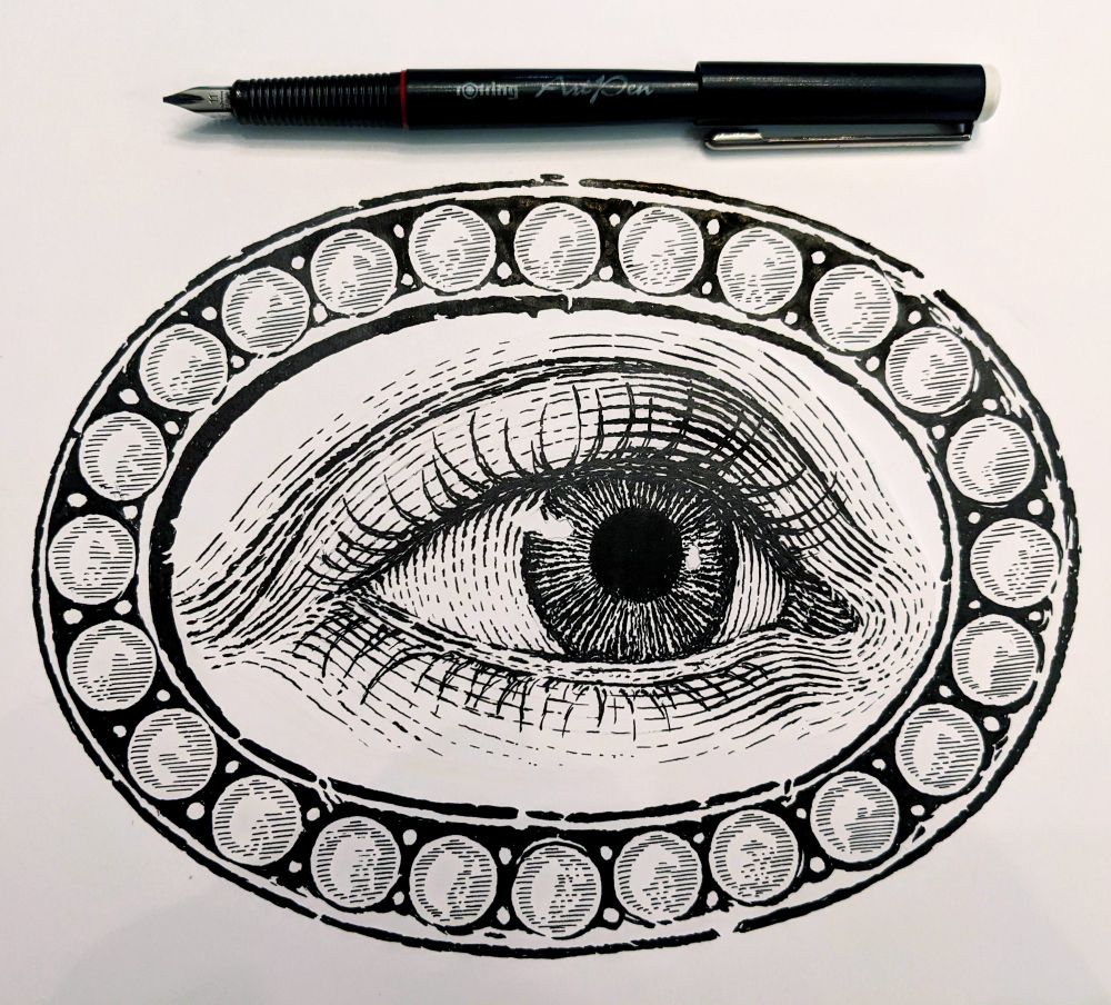 An ink drawing of a "Lover's Eye" brooch in an engraving style with a fountain pen