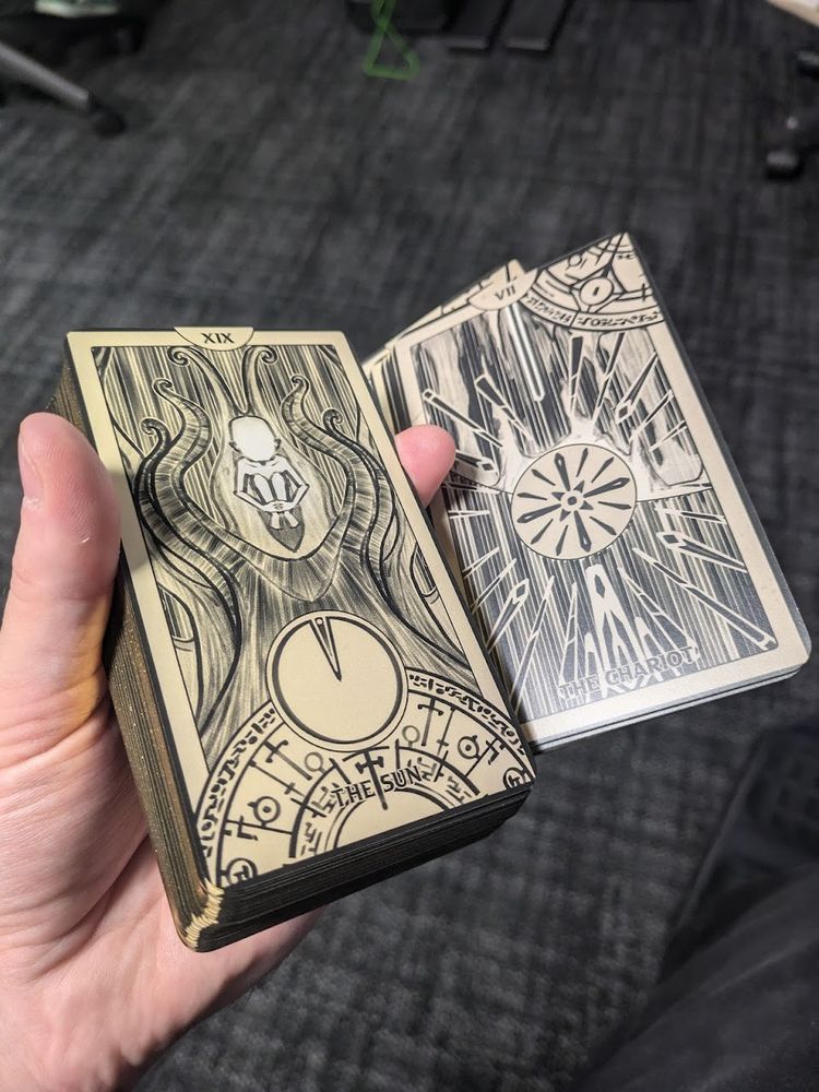 Photo of a Tarot Deck, showing 2 of the cards "The Sun" and "The Chariot"