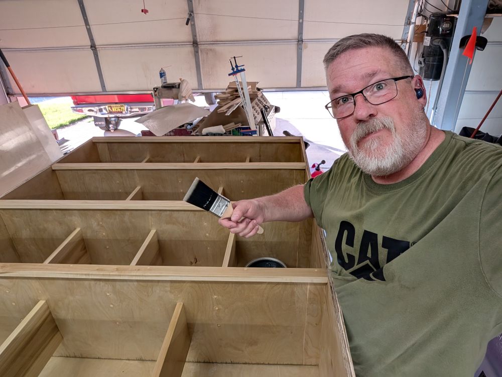 Buzz selfie standing over his vinyl record cabinet, as he's putting the second coat of polyurethane on. 