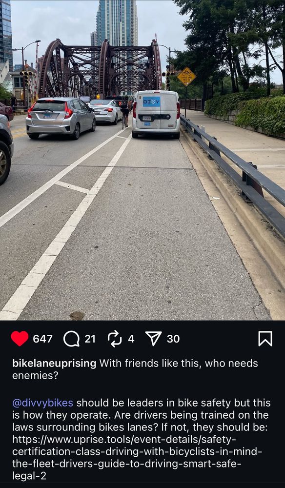 A Divvy Bikes maintenance (?) van parked in the bike lane crossing a bridge, showing a cyclist needing to navigate congested motorist traffic to get around it.