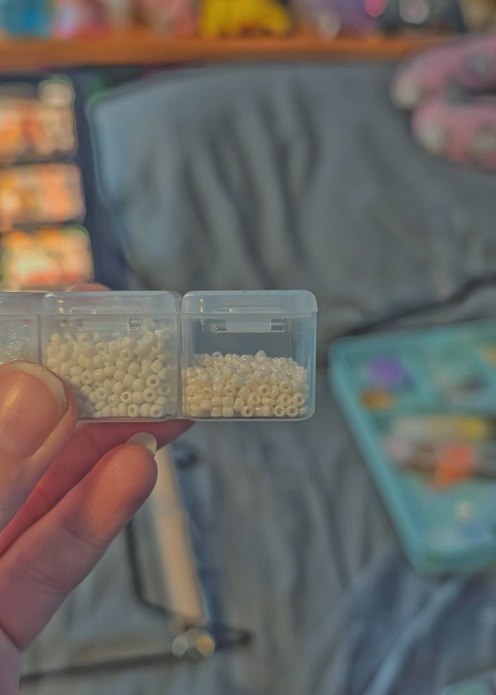 White beads in two square containers. One entirely full and the other half full