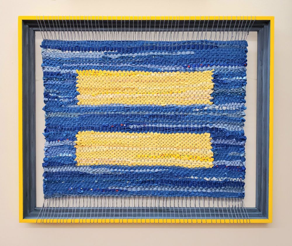 "Blue Skies and Sunshine" Woven Tapestry is of a recognizable sign for equality for all, a status that should be as natural as the elements and be a clear path for humanity.  Made using color and sustainable upcycled fabric on a recycled painted frame.
2023
Original Work by Amy C Lund 
21.5" W x 17.5" H in Frame
Featured at
Gallery X, 169 William Street, New Bedford, MA 02740
in Kaleidoscope
May 31 through June 25, 2023
Gallery X,169 William Street, New Bedford, MA 02740
in "Social Justice"
February 5 - March 8, 2025
