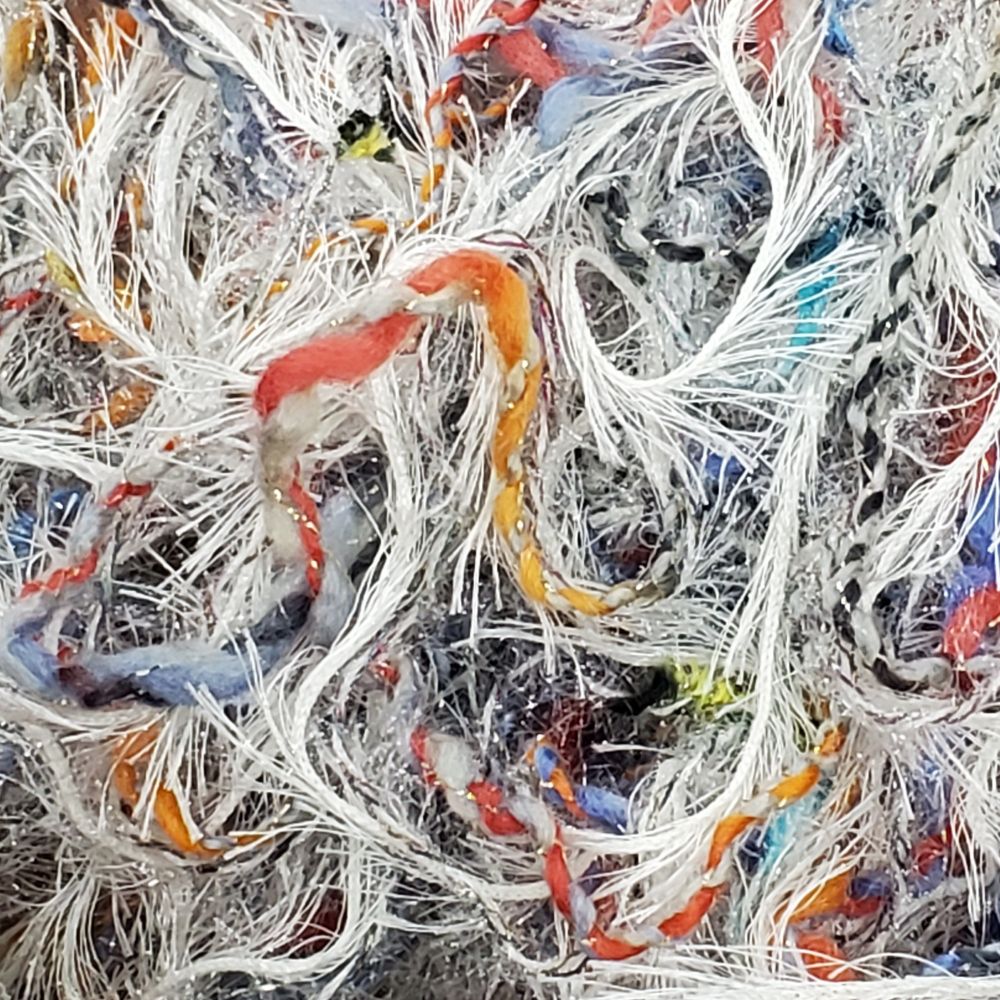 Loose yarn in a collage of textures and colors.