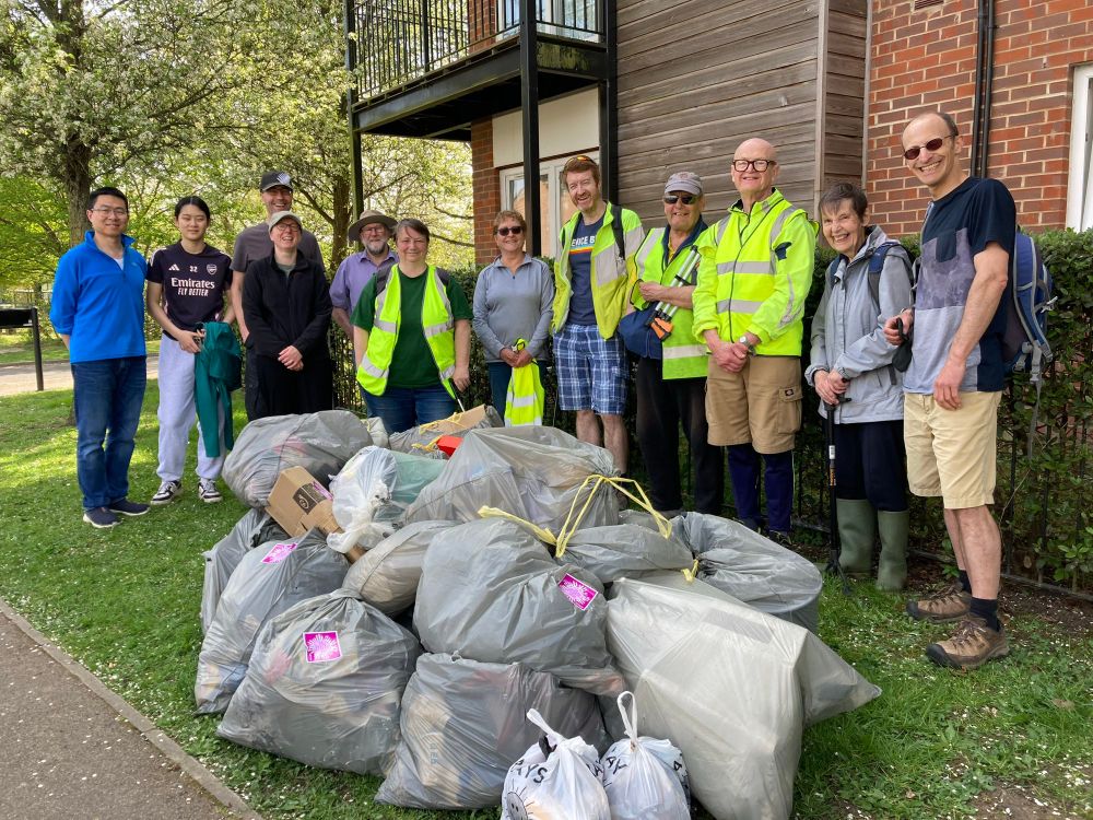 Keep Caversham Tidy volunteers stand weirdly behind their collected haul of litter