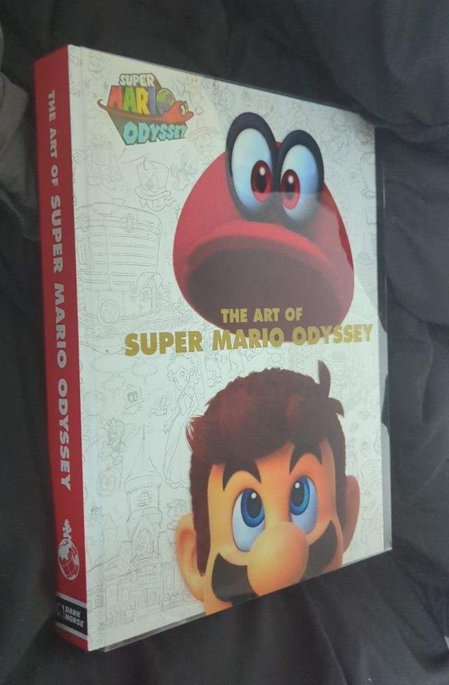 large and thick hardcover book titled "the art of super mario odyssey"