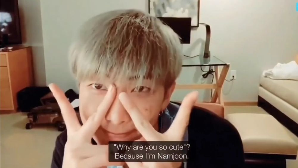 namjoon holding peace signs over his eyes. the caption says "'why are you so cute?' because i'm namjoon"