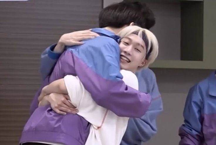 rui with a huge smile while lifting hao in a hug during boys planet