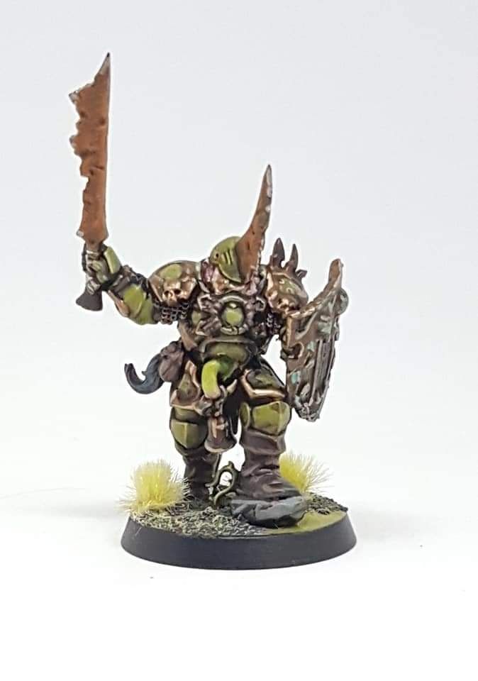 A warrior with a rusted sword and a massive horned helmet