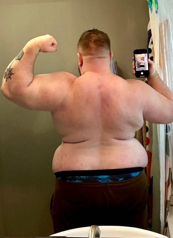A picture of the back side of a man flexing 