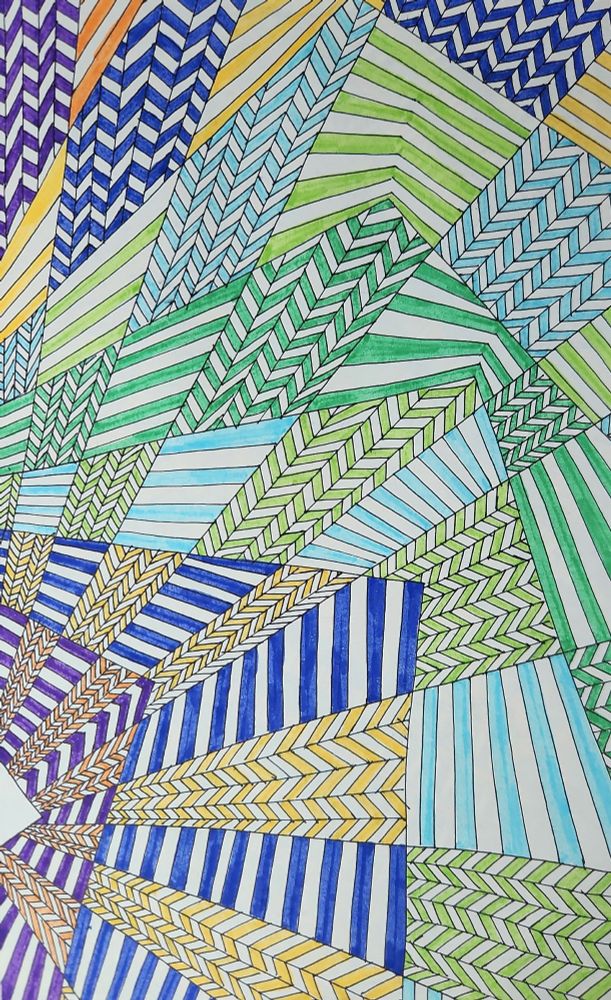 Doodles filling a page with alternating chevron and colored lines. The lines start purple on the left and become yellow toward the right. The chevrons start orange on the left, and end blue on the right.