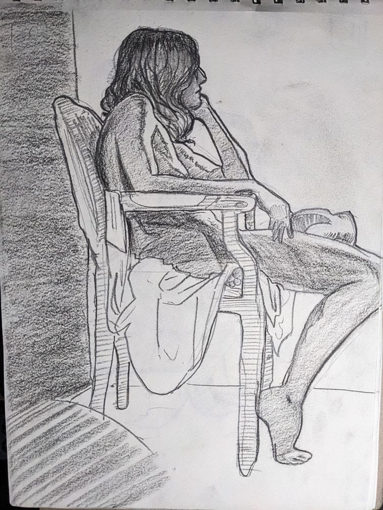 30 minute pose of a woman sitting in a chair  with her head in her hand from a side view 