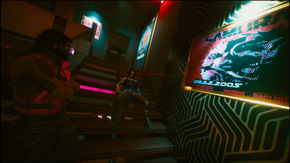 V (left) and Johnny Silverhand (right) loafing on a flight of stairs admiring a Samurai (Johnny’s Band) poster