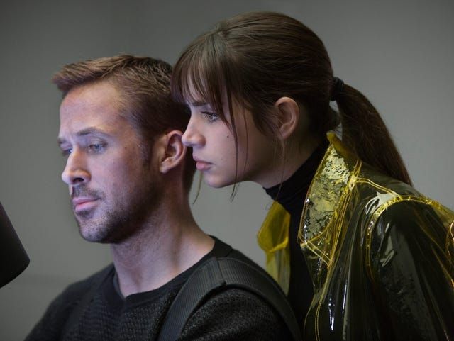 Ryan Reynolds in Blade Runner 2049 with an android Ana de Armas looking over his shoulder