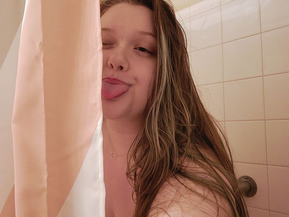 Bailey's hiding behind the shower curtain, sticking her tongue out at you. 