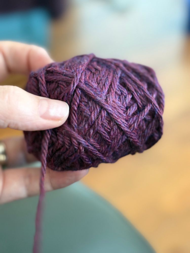 Close up of Berocco Vintage yarn in the colourway “Dried Plum”. 