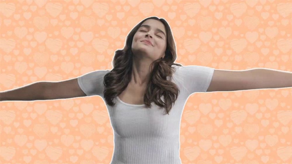 a woman with her arms outstretched in front of a heart pattern