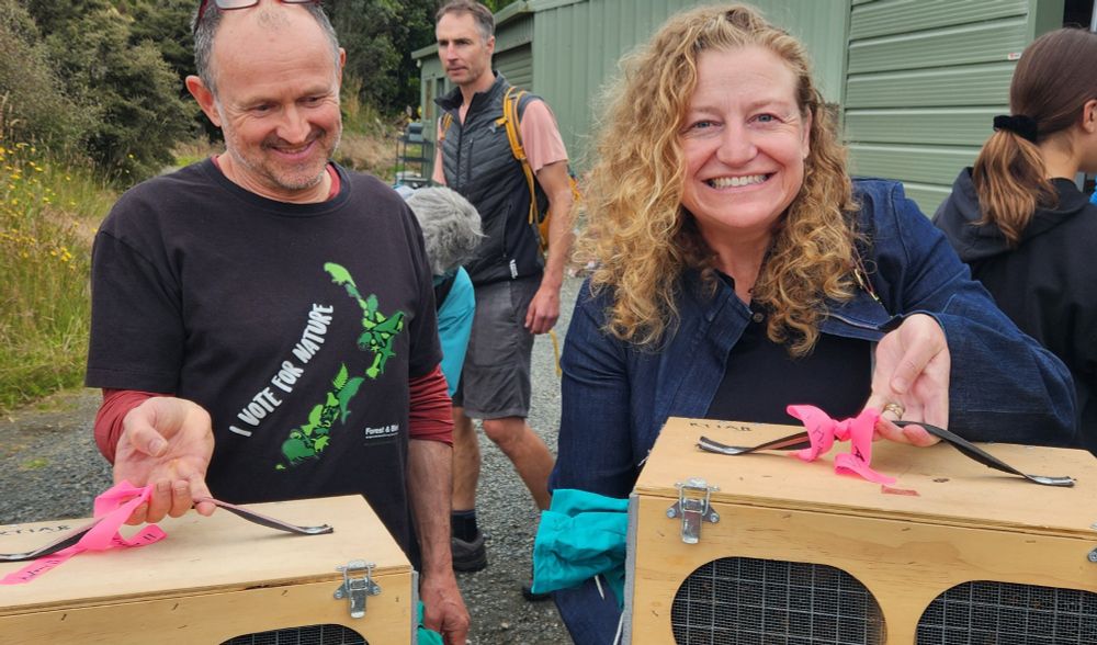Rachel Brooking MP & myself holding boxes containing precious tīeke (saddlebacks) prior to release