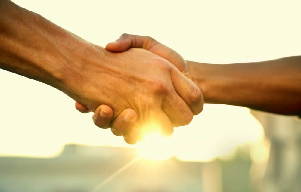 Picture of two people shaking hands.