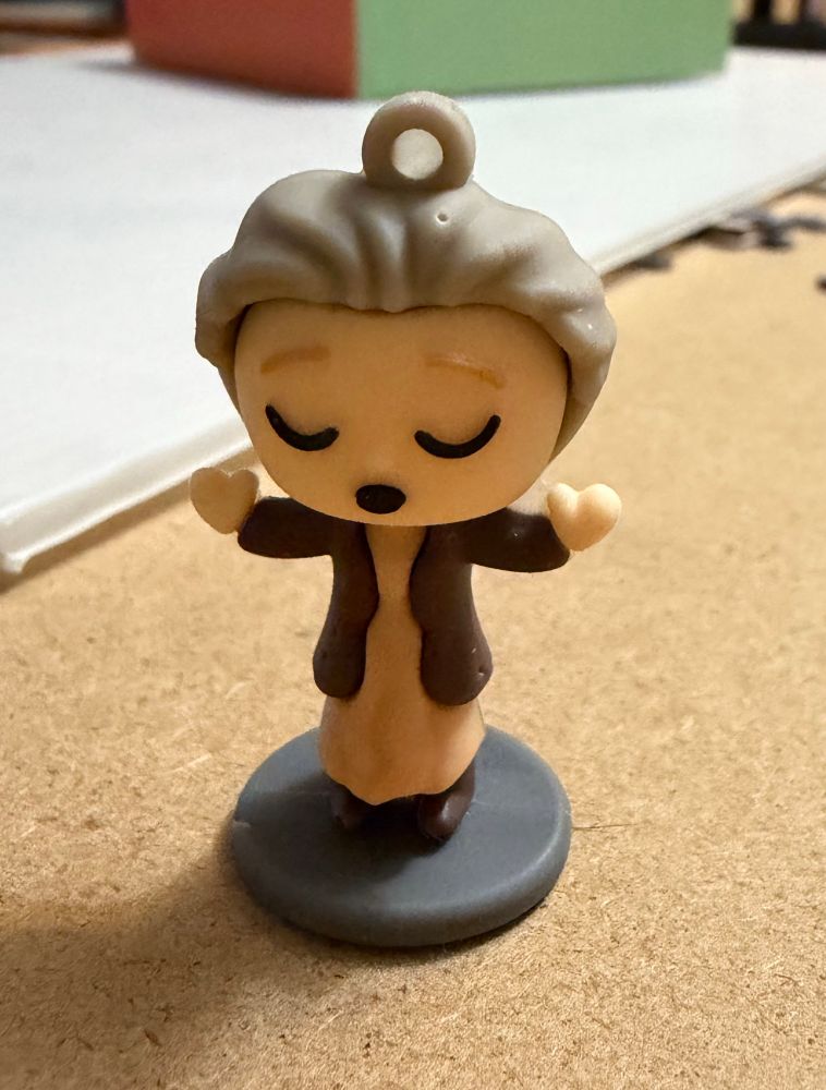 A Funko Pop style figurine of a woman with grey hair. 