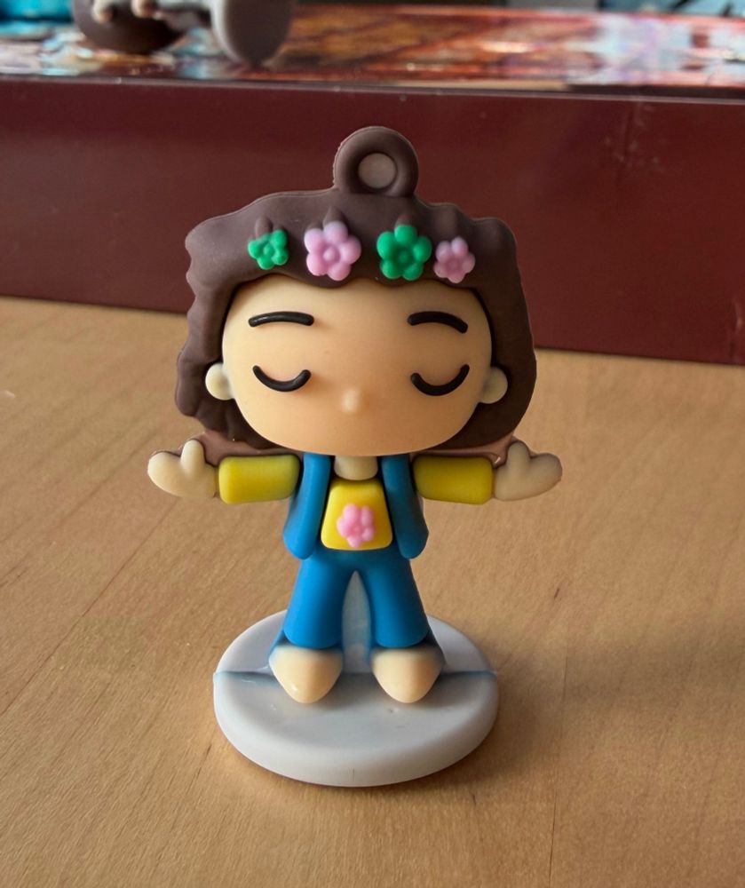 A Funko Pop style figure wearing flowers in its hair. 