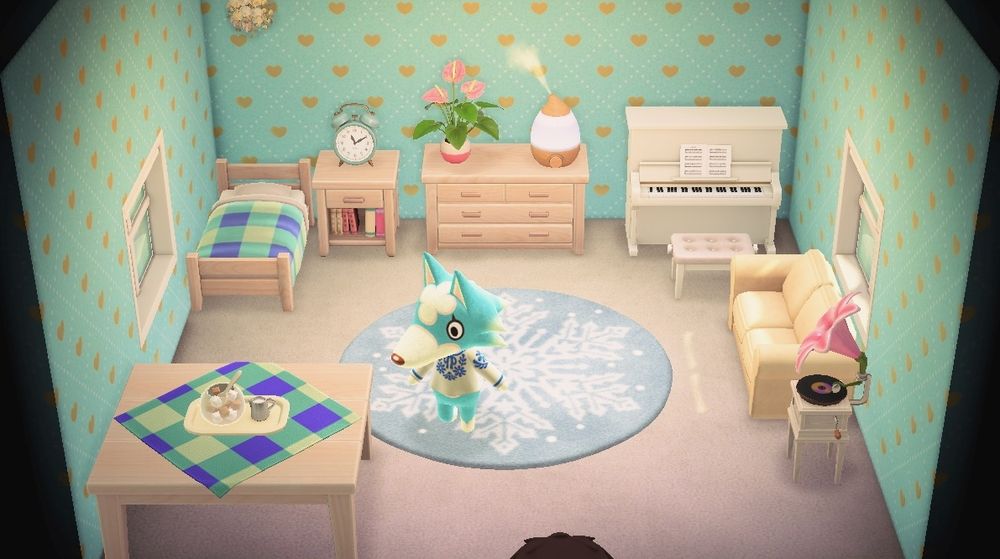 Screenshot of Skye's default room from Animal Crossing. The room has a light blue wallpaper, white floor, and various light colored furniture. In the middle there is a snowflake rug. Some of the furnitures have a blue checkered fabric on them 