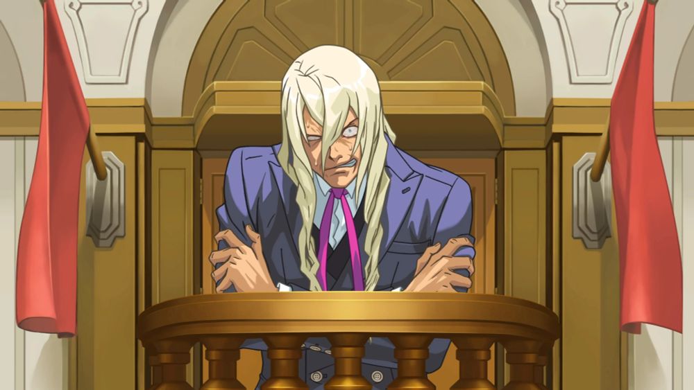 Kristopher Gavin from Ace Attorney after the breakdown scene. He's hunched over, with his hands gripping his shoulders and he has a disheveled hair and a manic expression with twitching eyes and shit 