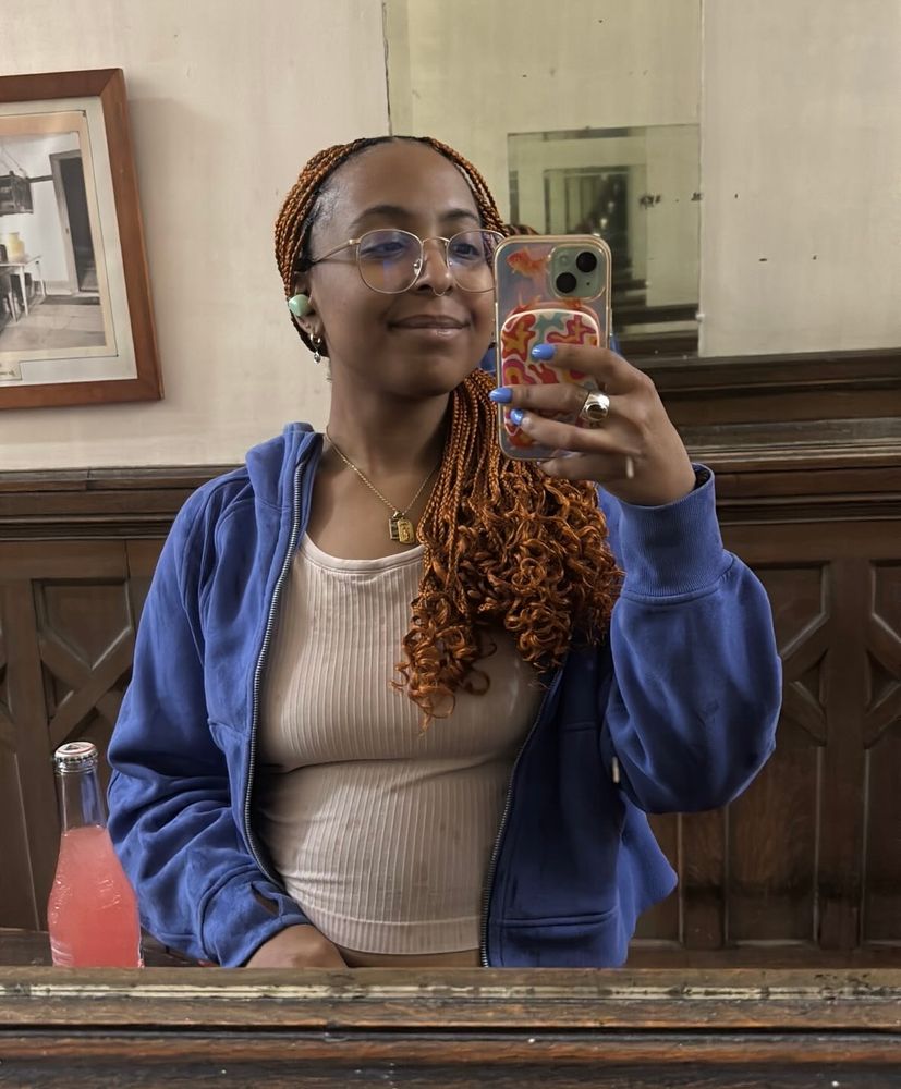 Mirror selfie where you can see rain droplets on my clothes from barely making it in from the downpour. Im in my lobby smiling a pleased smile cause life is okay sometimes. 