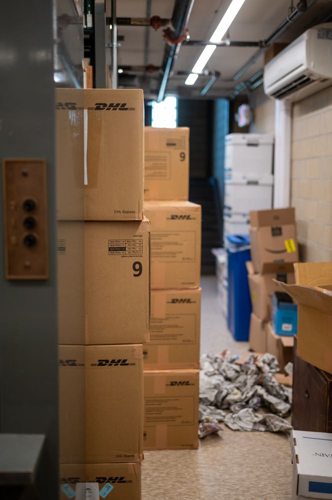 Boxes temporarily stored in the Ricci Institute Library stacks.