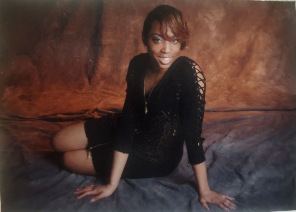 Professional photoshoot of me to celebrate my graduation. Wearing short auburn hair and a black Ed Hardy zip up dress.