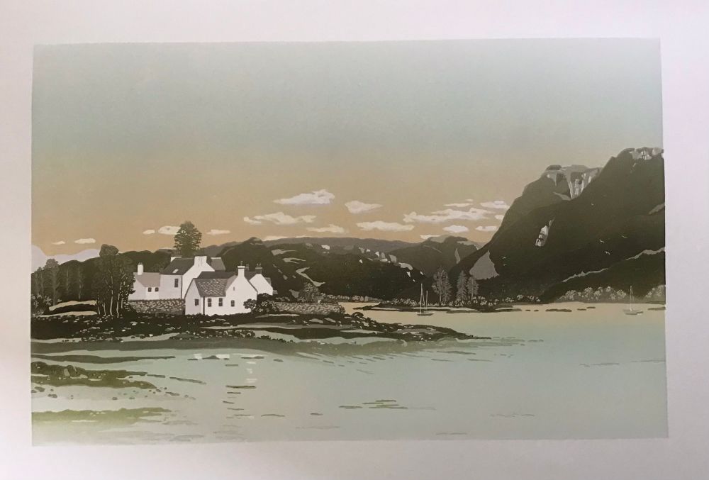 A linocut print that shows a small promontory jutting into a loch. There are whitewashed cottages to the left with a suggestion of reflections in the clear water in the foreground. In the background are the hills and then a yellowing, early morning sky peeping above them. White clouds hover above the hills and the sky graduates from yellow to a soft blue.