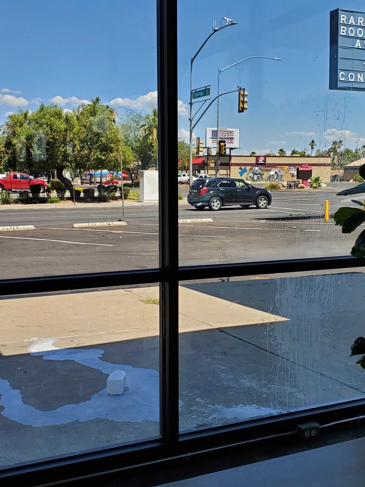 picture of the front windows and sidewalk at fangamer absolutely drenched in milk