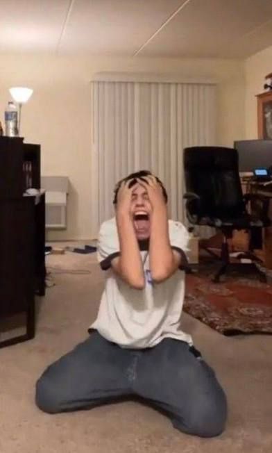 Meme image of a person on their news screaming with their hands on their head