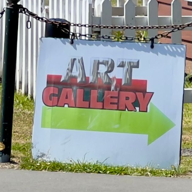 A sign that says the words “art gallery”. The word “art” has a gray wood texture that is hard to see on the white background, except that there is a thick red line behind it near the bottom of the letters. The word “gallery” is underneath, centred with the word above but not with the square sign, in a different thicker font, bright red with a thin black outline. Under all of this is a bright lime green arrow