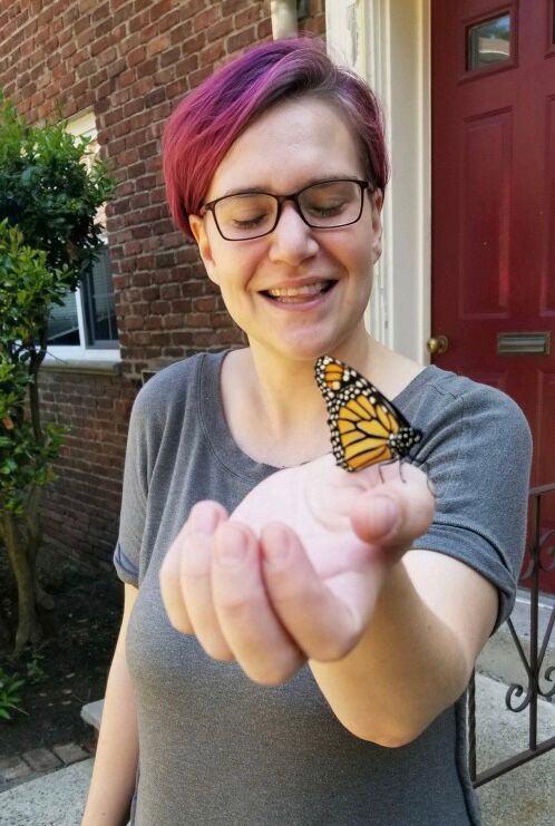 A purple haired weirdo holding one of the monarch butterflies they raised last year!