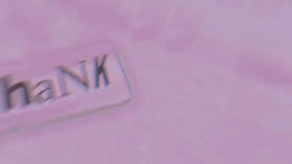 a pink background with a kiss and the words `` thank u , next '' cut out of paper .