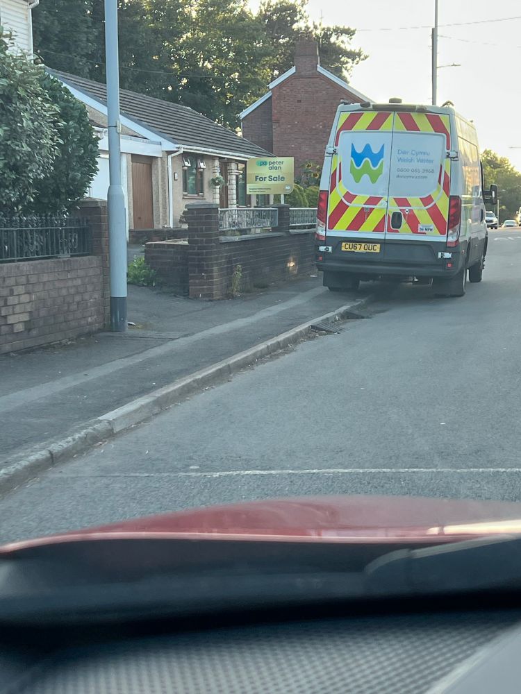 A Dwr Cymru / Welsh Water van parked obstructing the pavement in Gowerton, Swansea. 
