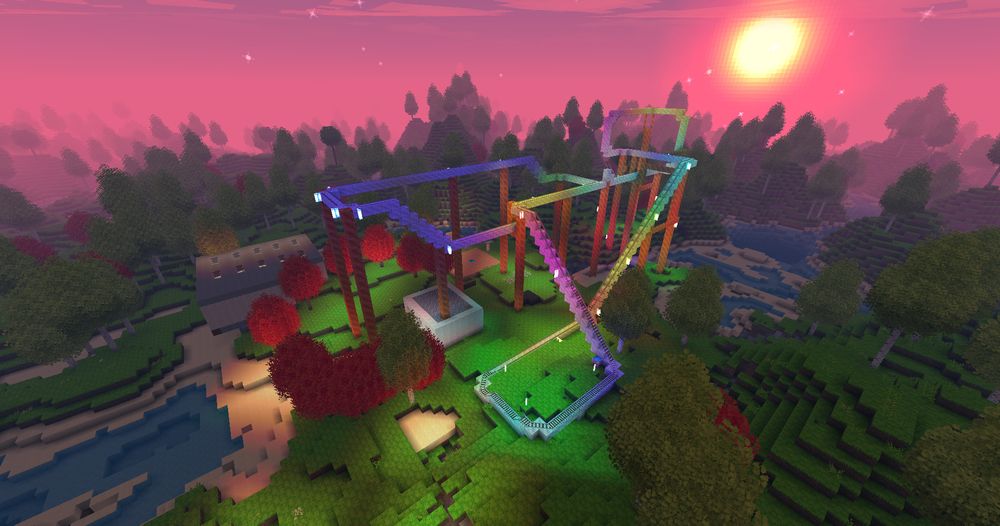 A rainbow roller coaster, surrounded by trees and buildings