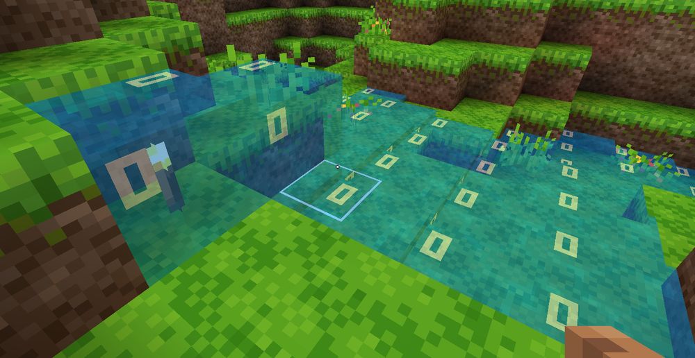 Water flowing through grass, with a torch placed inside