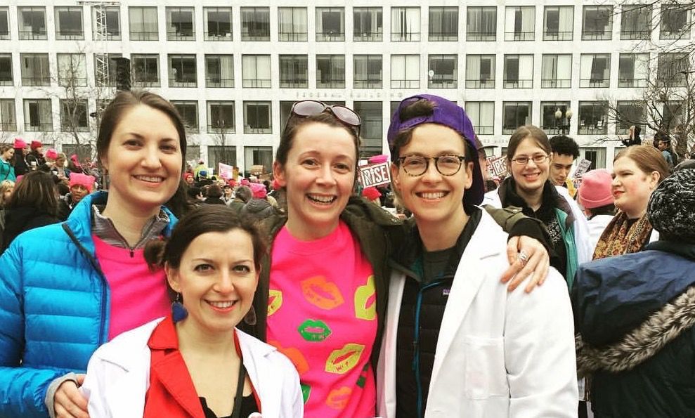 Four women scientists, including Kristin, pose for a picture at the Women’s March in January of 2017 in Washington, DC. 