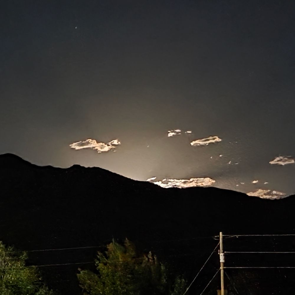 The Magdalena mountains just before the full moon crested 