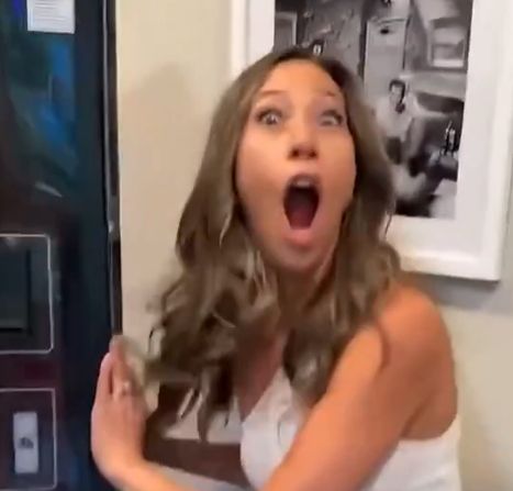 woman from the video pretending to be surprised by the vending machine secret entrance