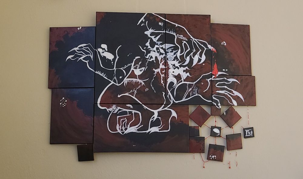 A large 4 x 3ft painting of a scary figure outlined in white with multiple arms. It has spikes and eyes trailing down its back.

The background is a bloody swirl on top of black, eyes seen throughout the image. The bottom right corner contains a cluster of smaller canvases bound together by strings of red beads.