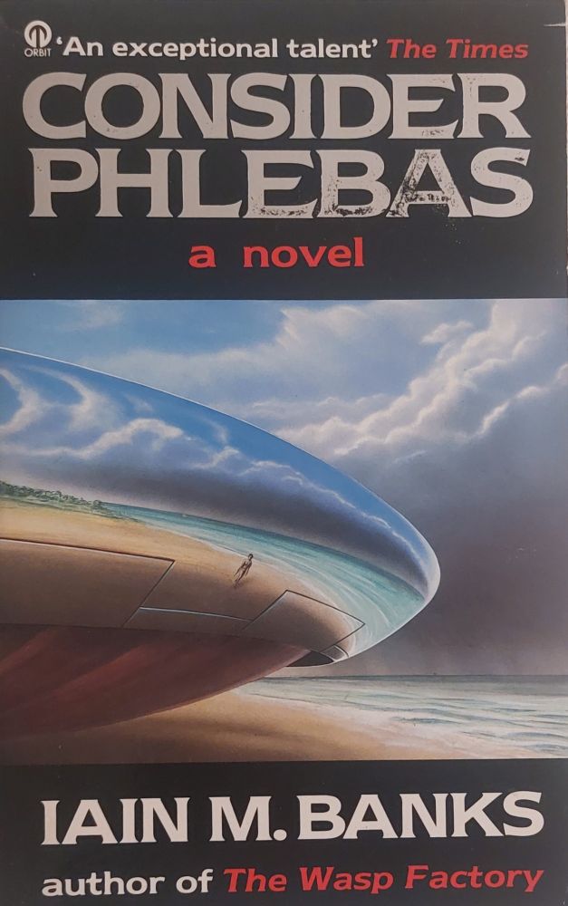 A smooth, sleek, disc shaped spaceship  sits on a beach next to an ocean. The reflection on the spaceship shows sand, sea, sky, and a single person on the beach.