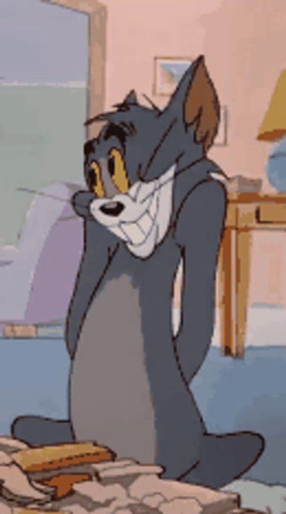 a tom and jerry cartoon is sitting on a bed