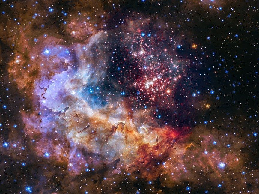 The sparkling centerpiece of Hubble's silver anniversary tribute is Westerlund 2, a giant cluster of about 3,000 stars located 20,000 light-years away in the constellation Carina. Hubble's near-infrared imaging camera pierces through the dusty veil enshrouding the stellar nursery, giving astronomers a clear view of the dense concentration of stars in the central cluster. The 2-million-year-old giant star cluster measures about 6 to 13 light-years across and contains some of our galaxy's hottest, brightest, most massive stars.