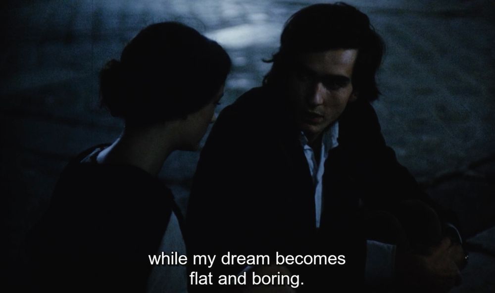 A nighttime scene from Robert Bressson's Four Nights of a Dreamer 91971) in which Jacques (Guillaume des Forêts) tells Marthe (Isabelle Weingarten) "I see people in turmoil and rage while my dream becomes flat and boring." 