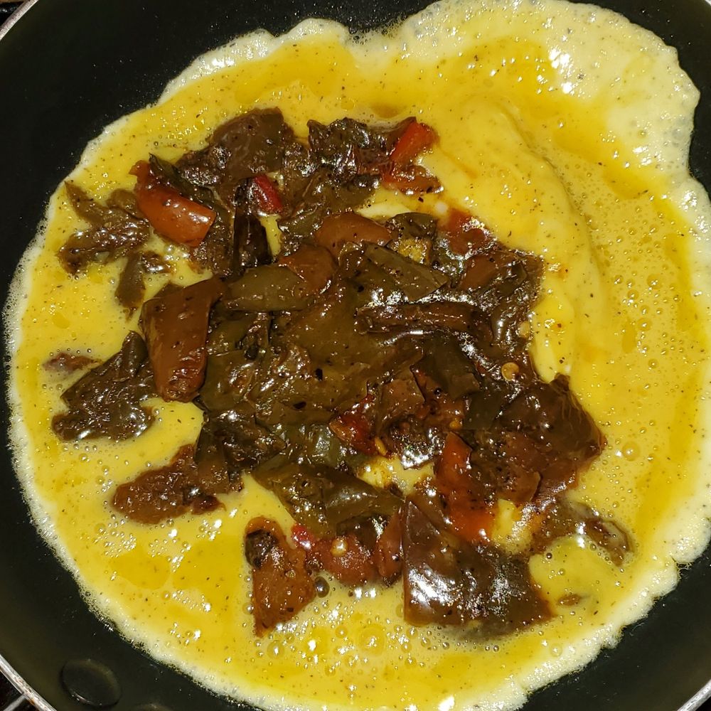 Scrambled eggs with the sautéed sweet peppers added.
