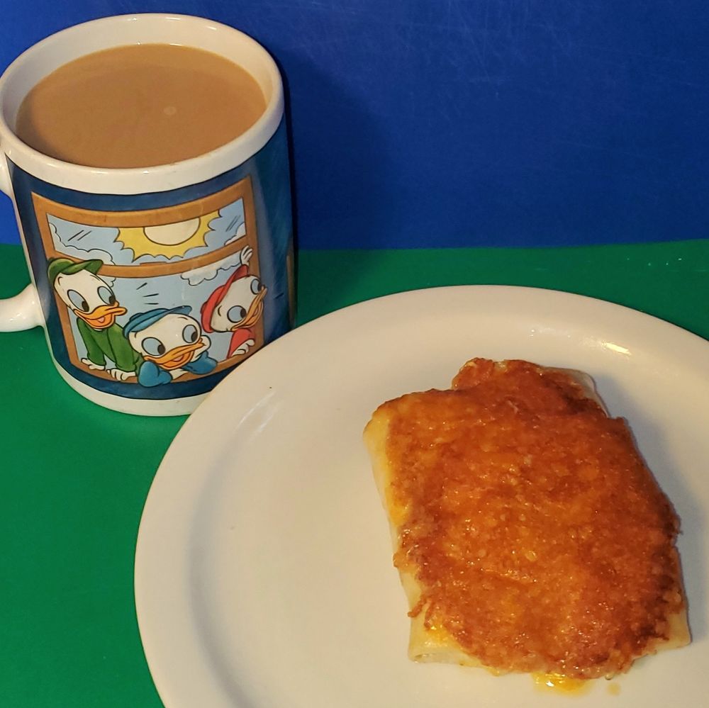 Dunkin Colombian coffee with Dunkin creamer in a Huey, Dewey, and Louie mug, and a grilled turkey chorizo and egg burrito. 